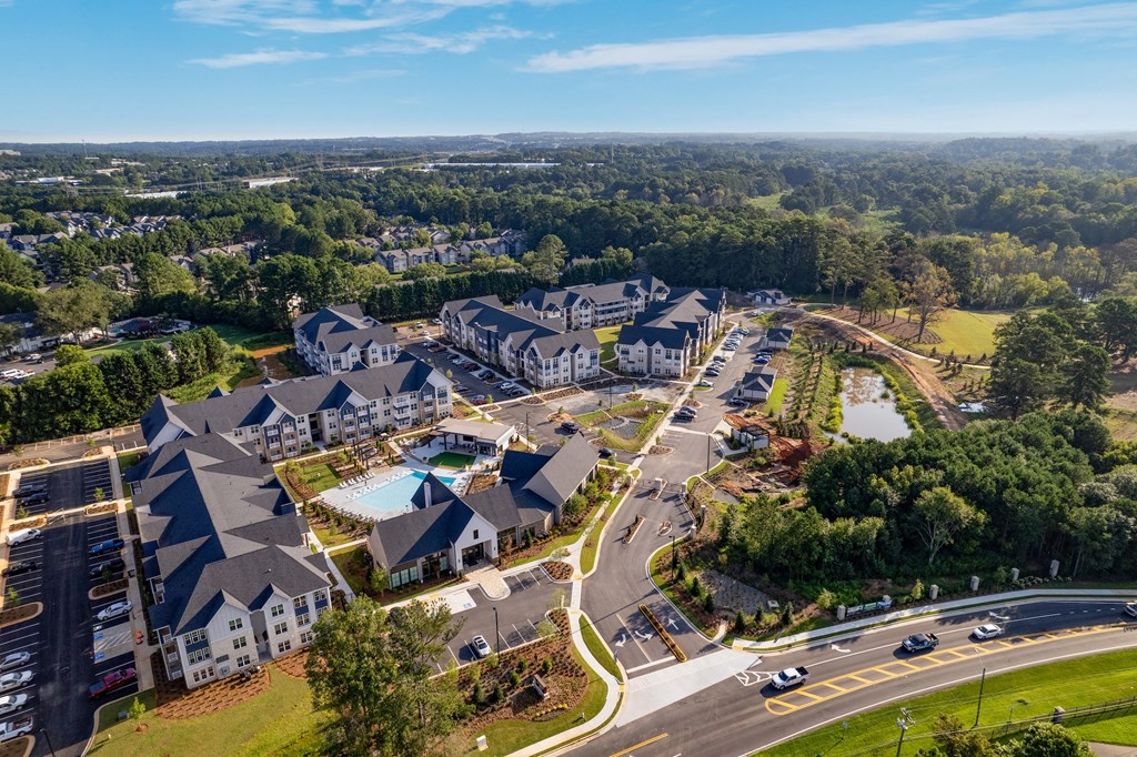 an aerial view of a large complex of buildings with a pool in the middle of the road