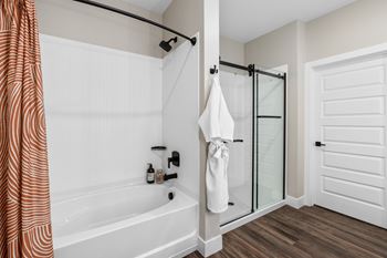 the preserve at ballantyne commons apartment bathroom with tub and shower