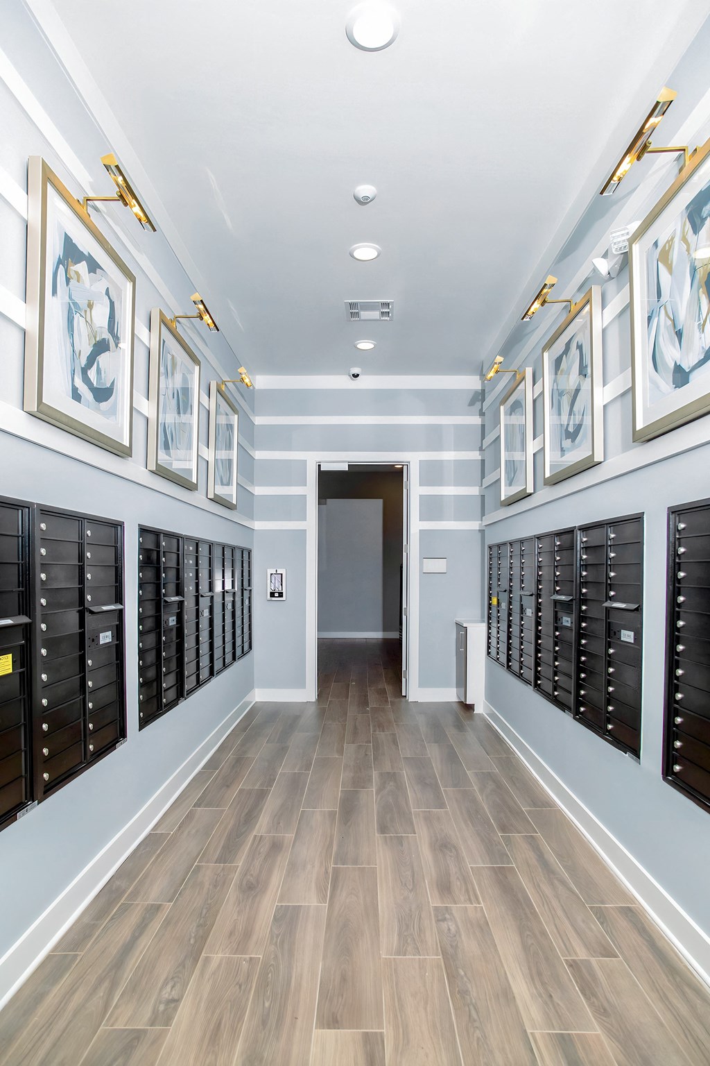 a long hallway with a closet filled with wine racks and a door