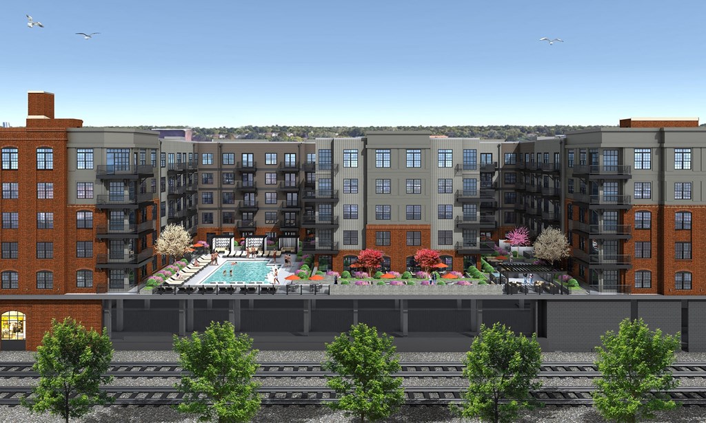 an aerial view of an apartment building with a swimming pool