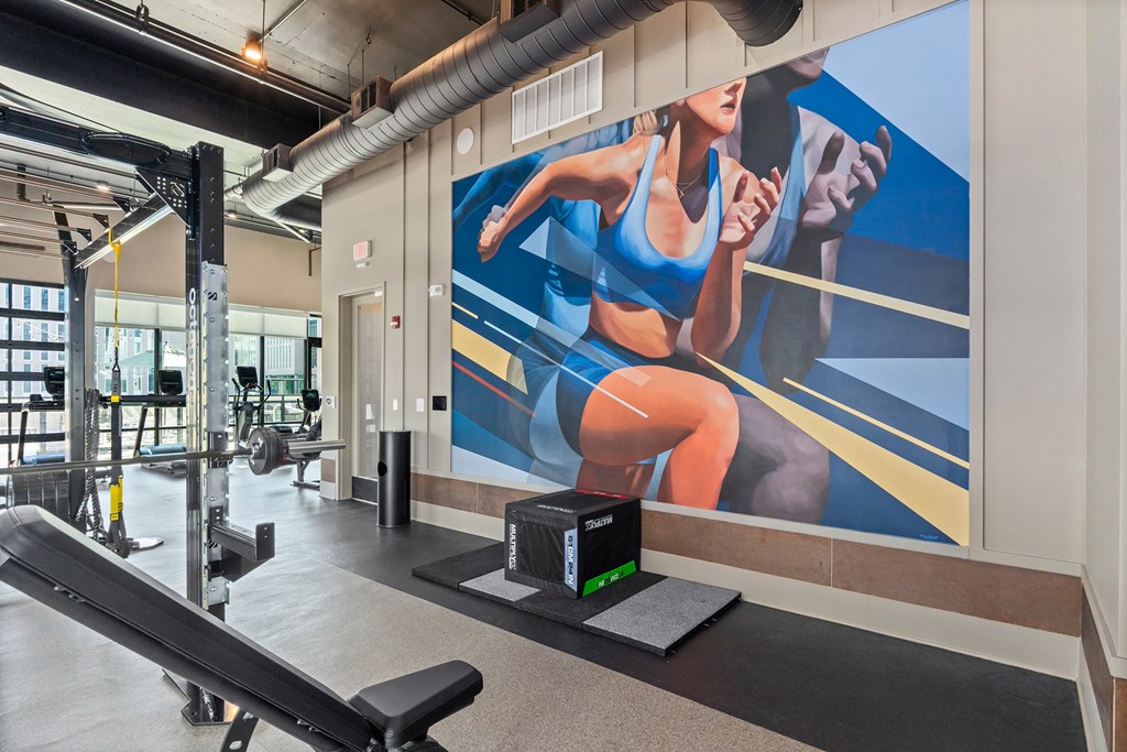A woman is running on a treadmill in a gym.