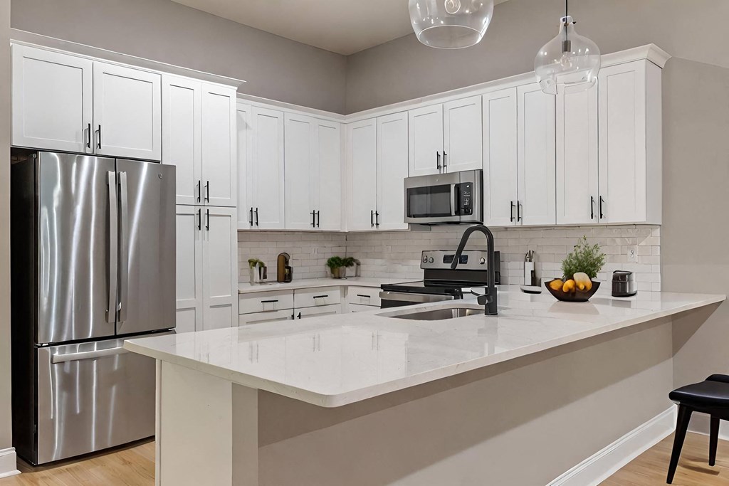 a kitchen with white cabinets and a counter top