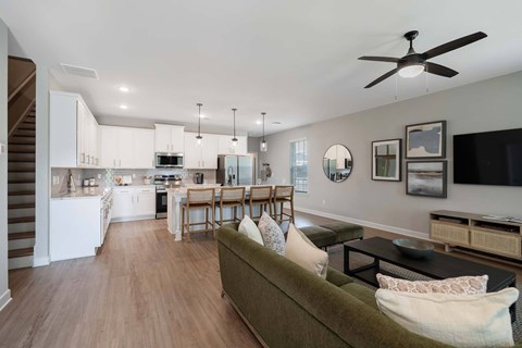 A living room with a couch and a dining table.
