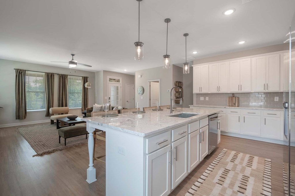 A modern kitchen with a large island and a dining area.