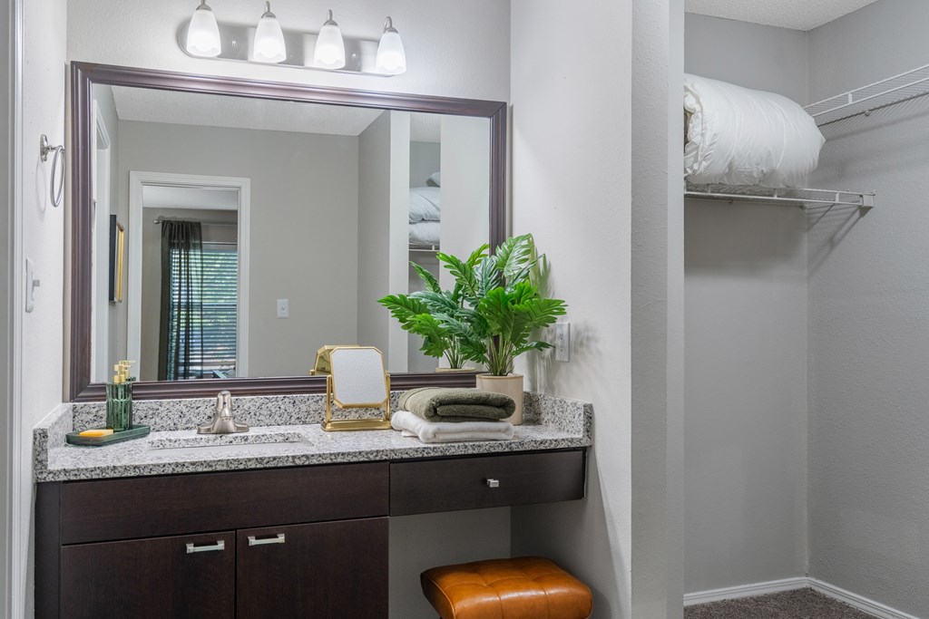 A bathroom with a vanity and a mirror.