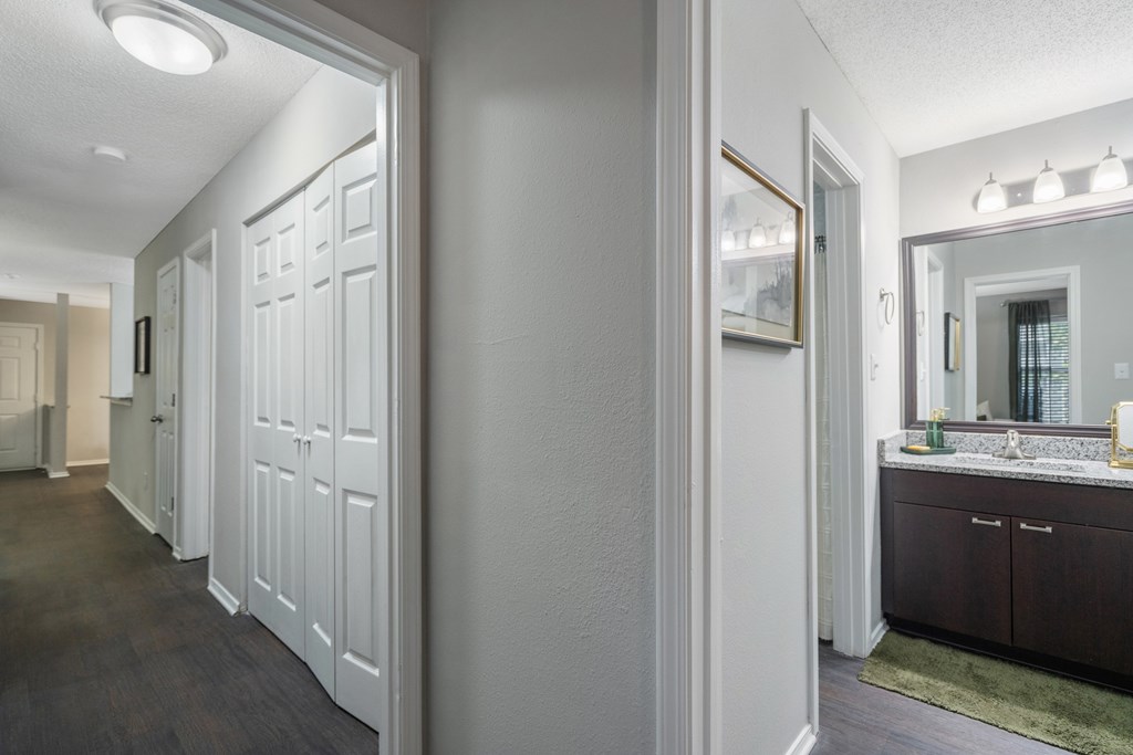A bathroom with a vanity and a mirror.