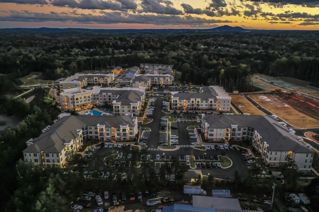 an aerial view of an apartment complex at sunset