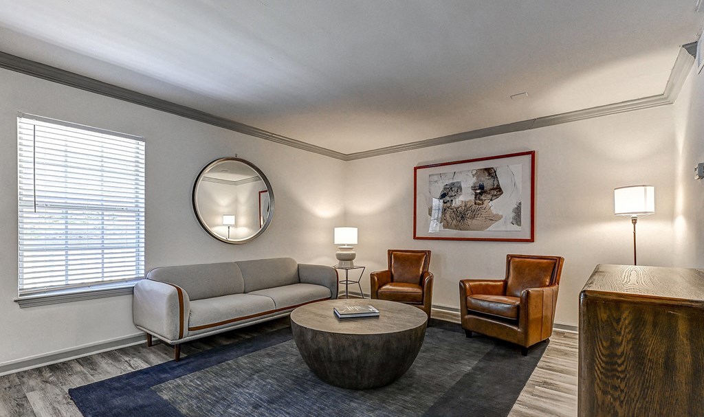 a living room with a couch chairs and a coffee table