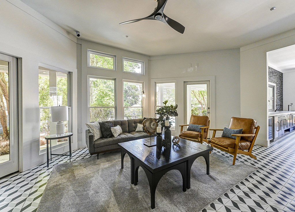 a living room with a couch chairs and a coffee table
