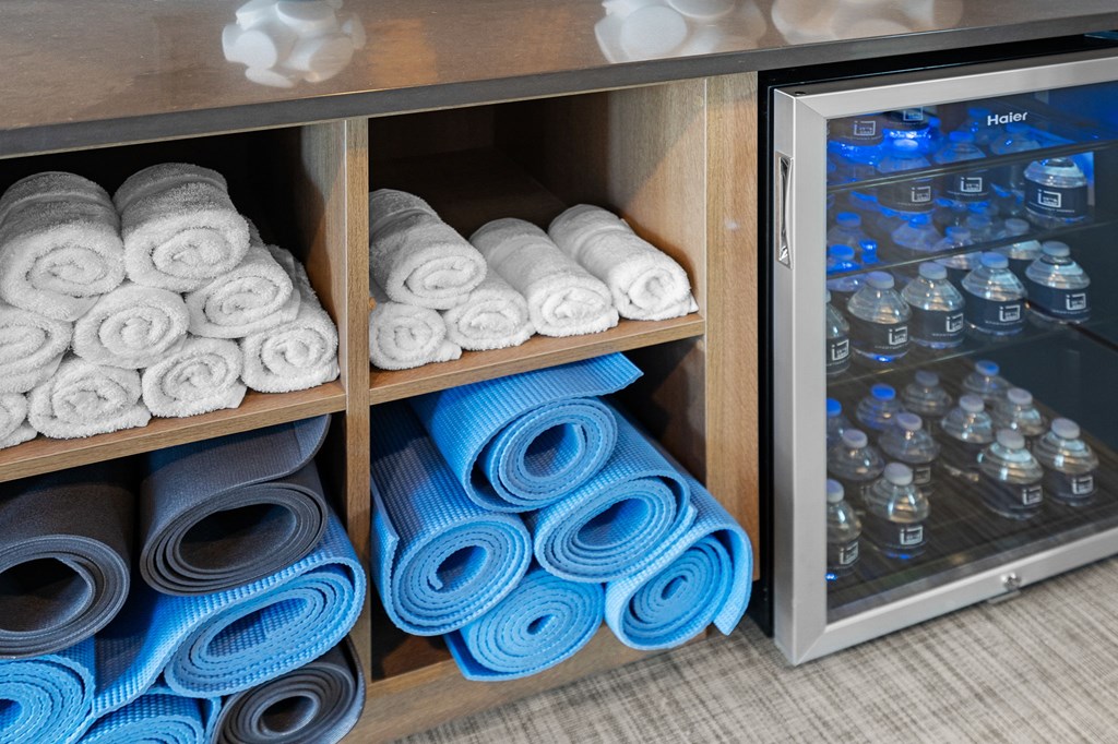 Towels are neatly folded and stacked in a storage cabinet.