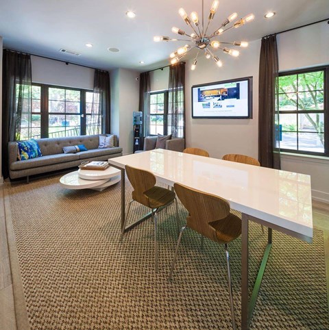 A modern dining room with a white table and chairs.