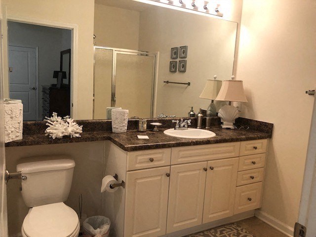 a bathroom with a toilet and a sink and a mirror