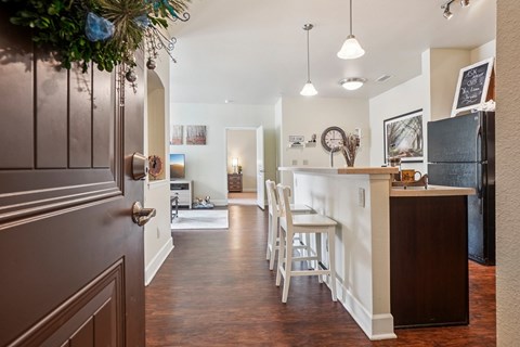 A kitchen with a bar and a dining table.