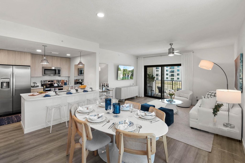 a living room and kitchen with a table and chairs