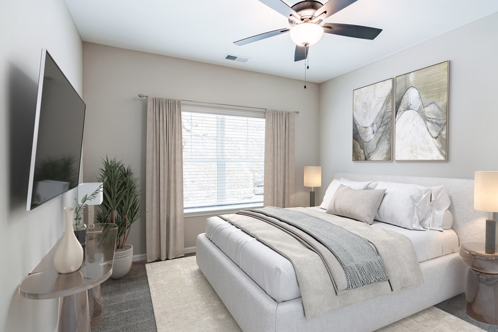 a bedroom with a bed and a ceiling fan