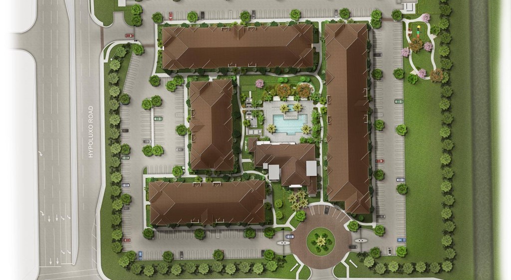 A bird's eye view of a residential area with houses, trees, and a fountain.