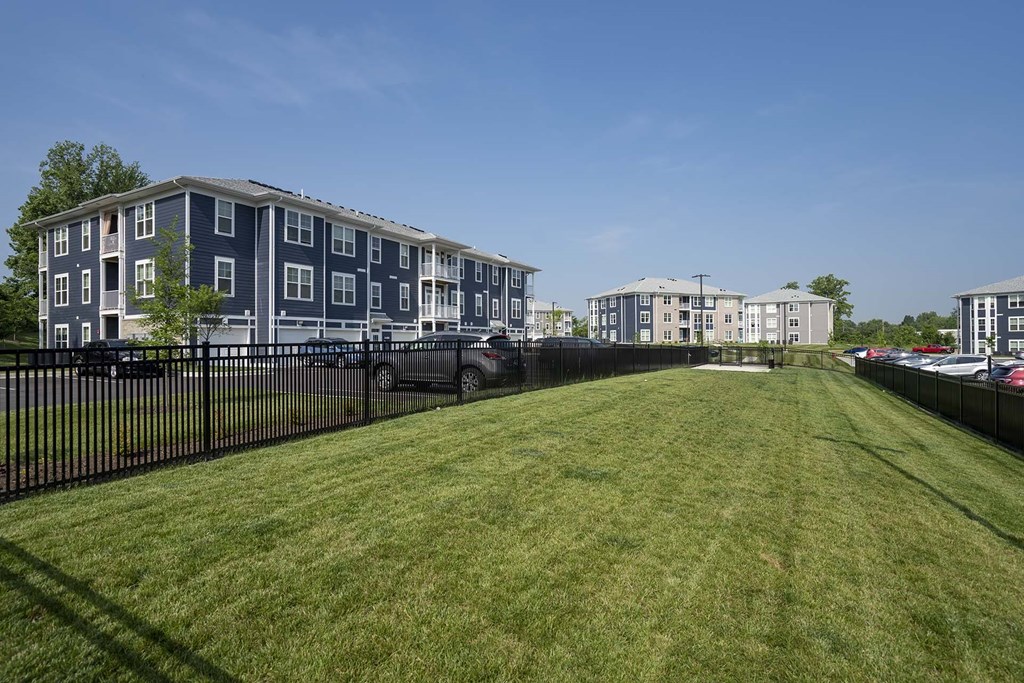 A grassy area in front of apartment buildings.