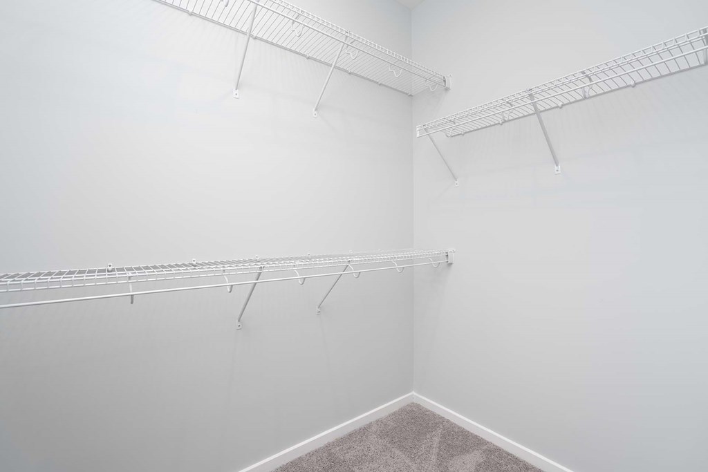 A white room with three metal racks on the wall.