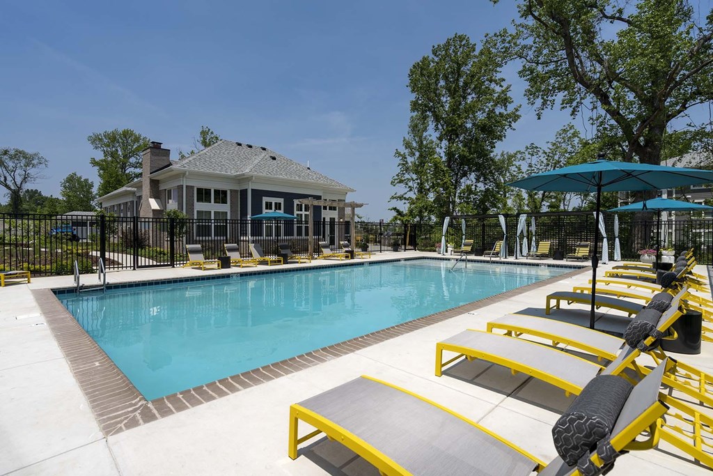 A pool with a yellow and black lounge chair.