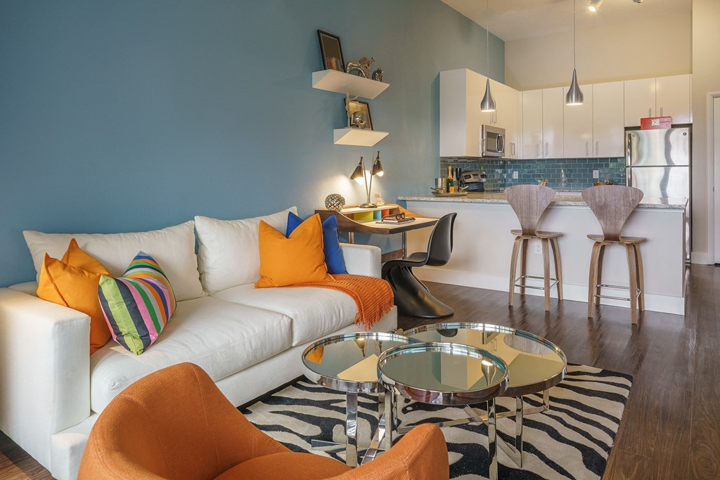 a living room with a white couch and a glass table