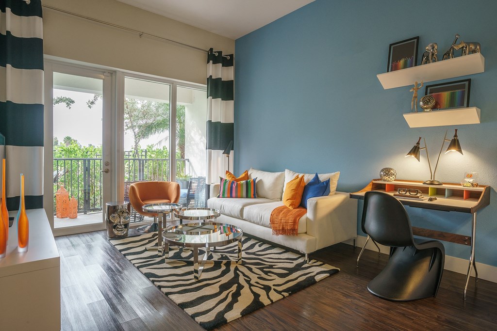 a living room with blue walls and orange and white furniture