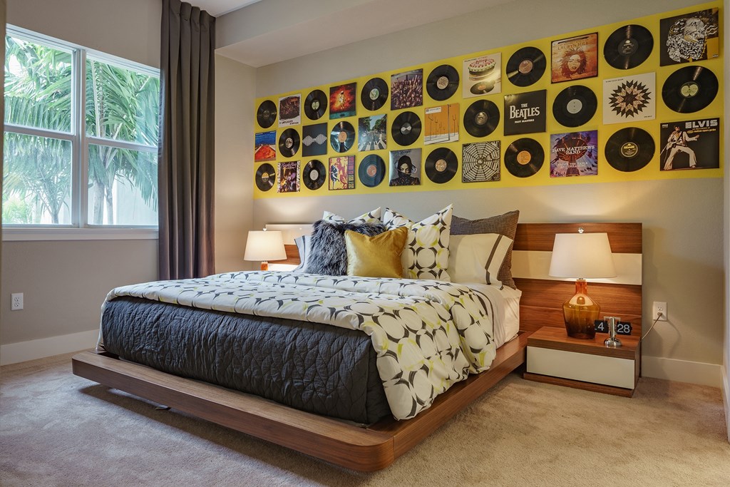 a bedroom with a bed and a wall of records