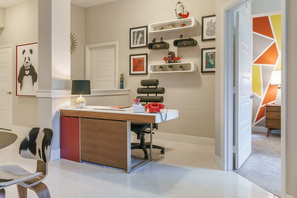 a home office with a desk and a chair