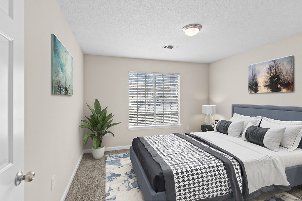 a bedroom with a bed and a potted plant