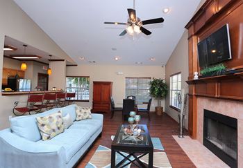 a living room with a fireplace and a blue couch