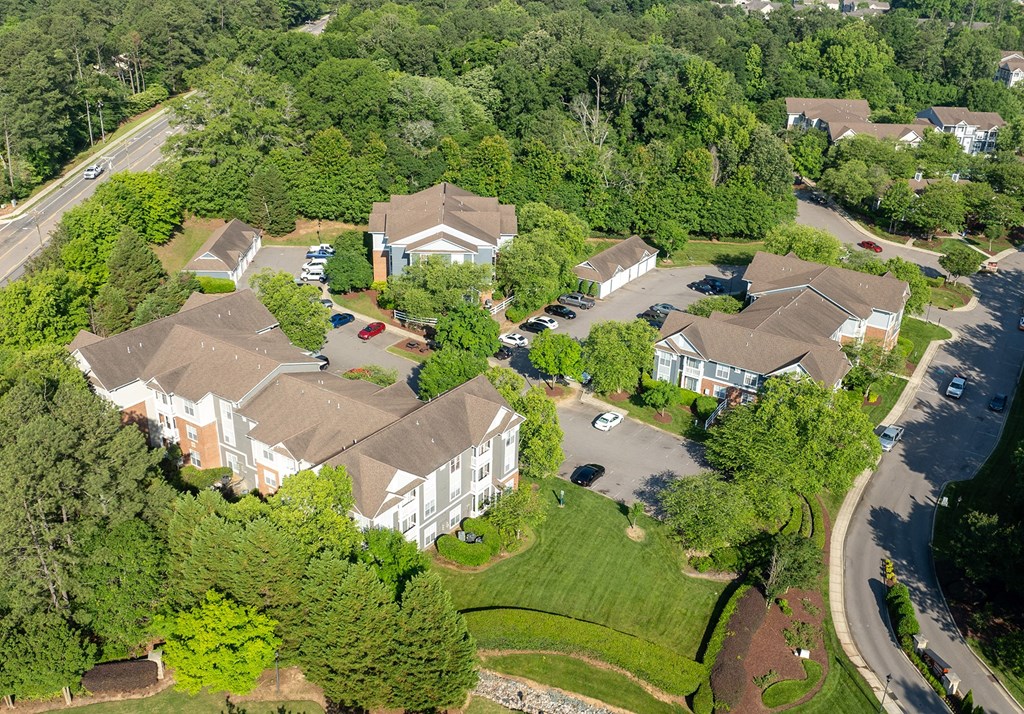 a aerial view of a neighborhood of houses with cars parked in front of them