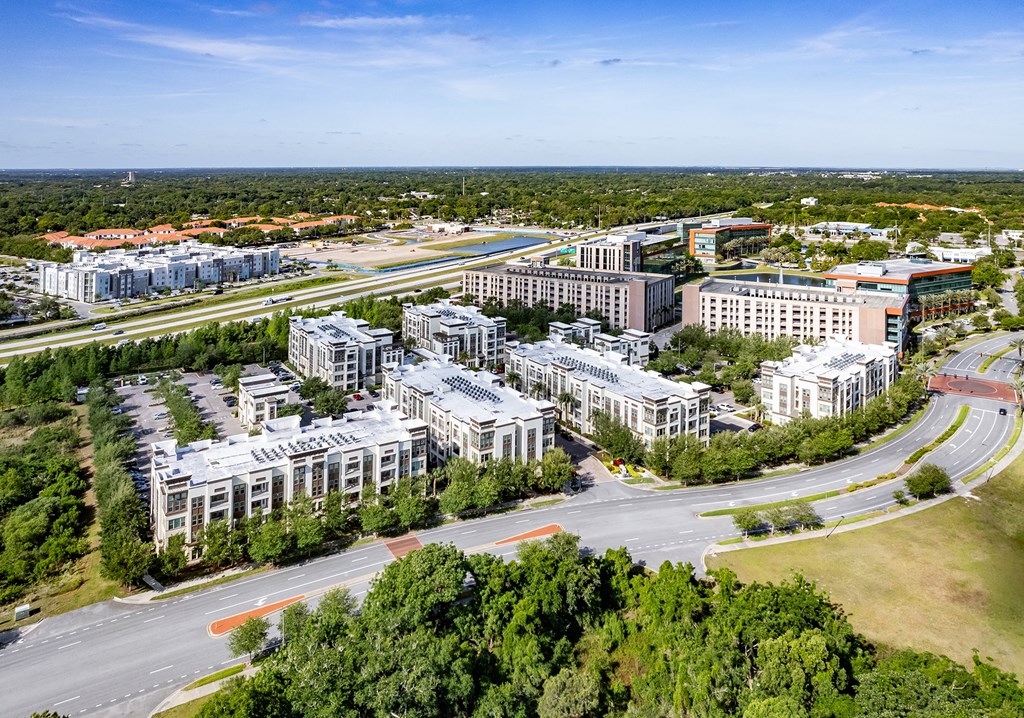 an aerial view of a city with buildings and a highway