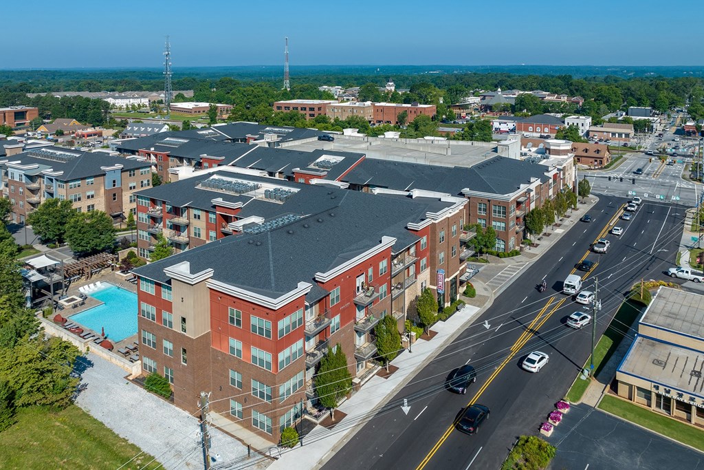 an aerial view of a building with a swimming pool