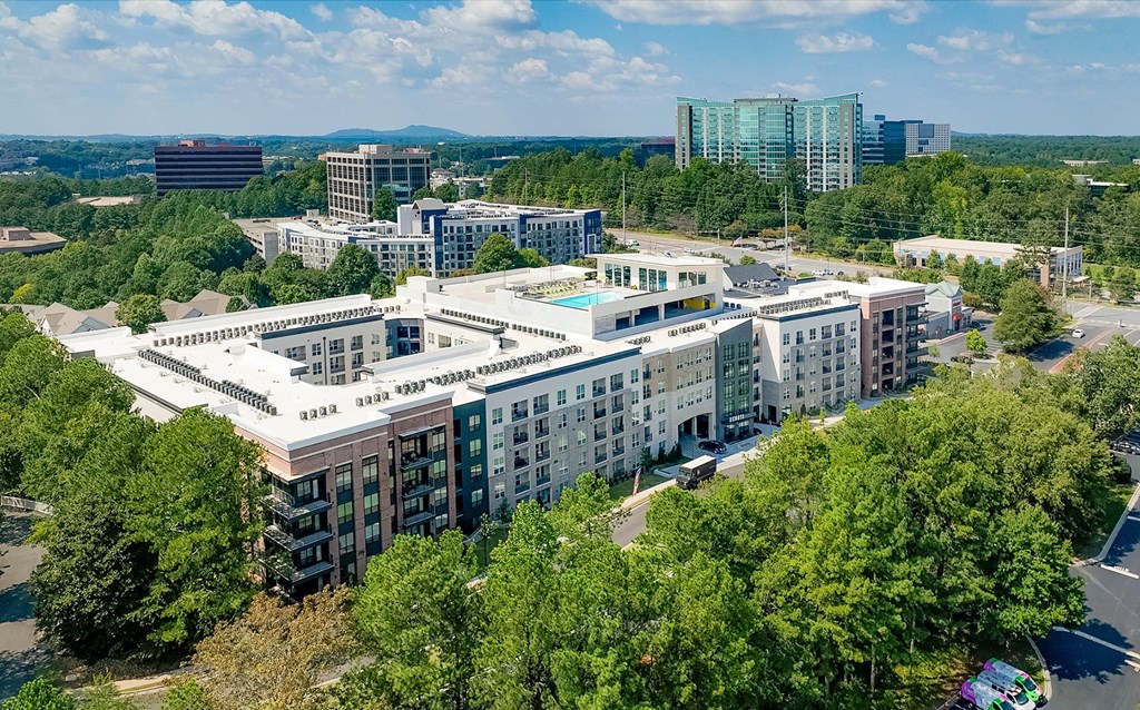 an aerial view of a city with buildings and trees