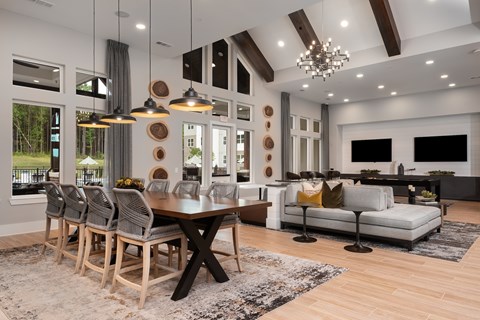 A modern dining room with a wooden table and chairs.