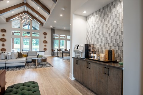 A modern kitchen with a large island and a dining area with a table and chairs.