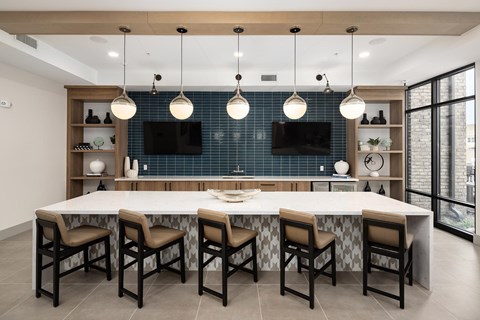 A modern dining room with a large table and chairs.