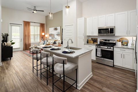 A kitchen with a dining table and chairs.