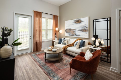 A living room with a red chair and a white couch.