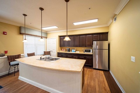 A kitchen with a wooden counter top and stainless steel appliances.