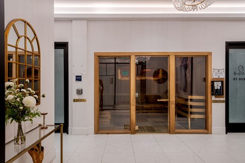 A glass door with a gold frame is the main focus of the image.