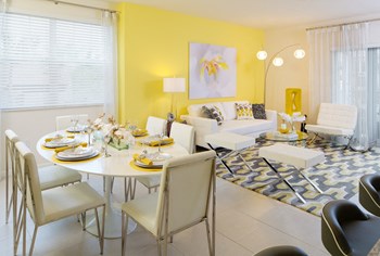 a living room with yellow walls and a dining room with a white table and chairs - Photo Gallery 25