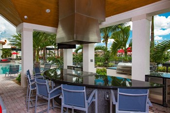 a view of the outdoor kitchen and pool area at the resort at longboat key club - Photo Gallery 8