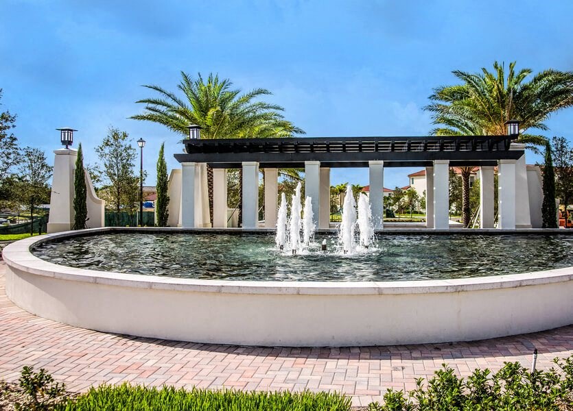 a fountain in front of a building with palm trees in the background at Altis Kendall Square, Miami Florida