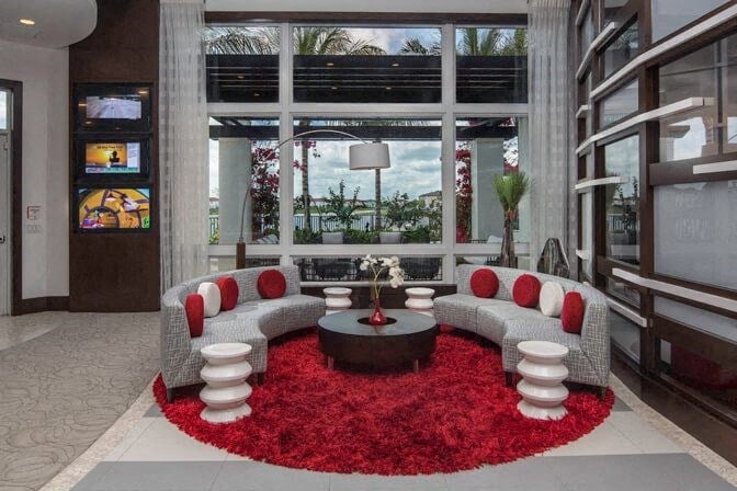a living room filled with furniture and a large window at Altis Kendall Square, Miami, 33196