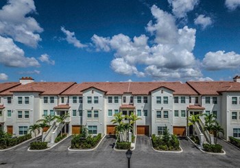 a large apartment complex with a blue sky in the background - Photo Gallery 15