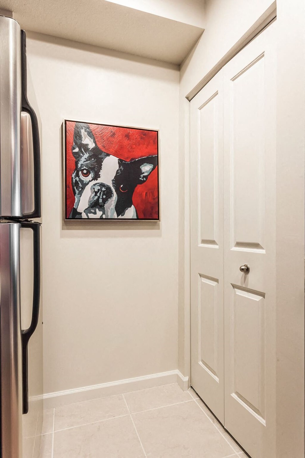 a painting of two dogs hanging on a wall in a kitchen at Altis Kendall Square, Miami, 33196
