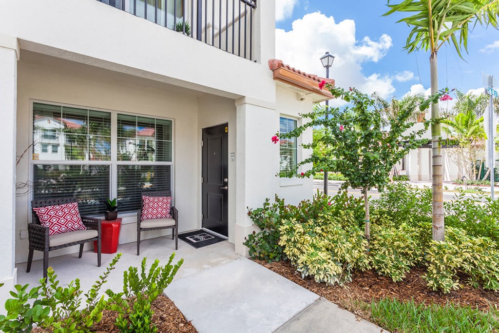 a patio with two chairs and a tree at Altis Kendall Square, Miami Florida