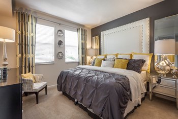 a bedroom with gray walls and a yellow and gray bedspread - Photo Gallery 16