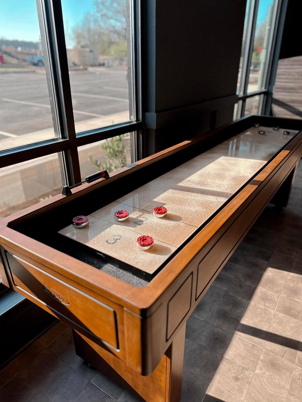 an old shuffleboard table in a room with windows