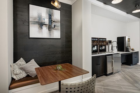 A modern kitchen with a wooden table and a bench.